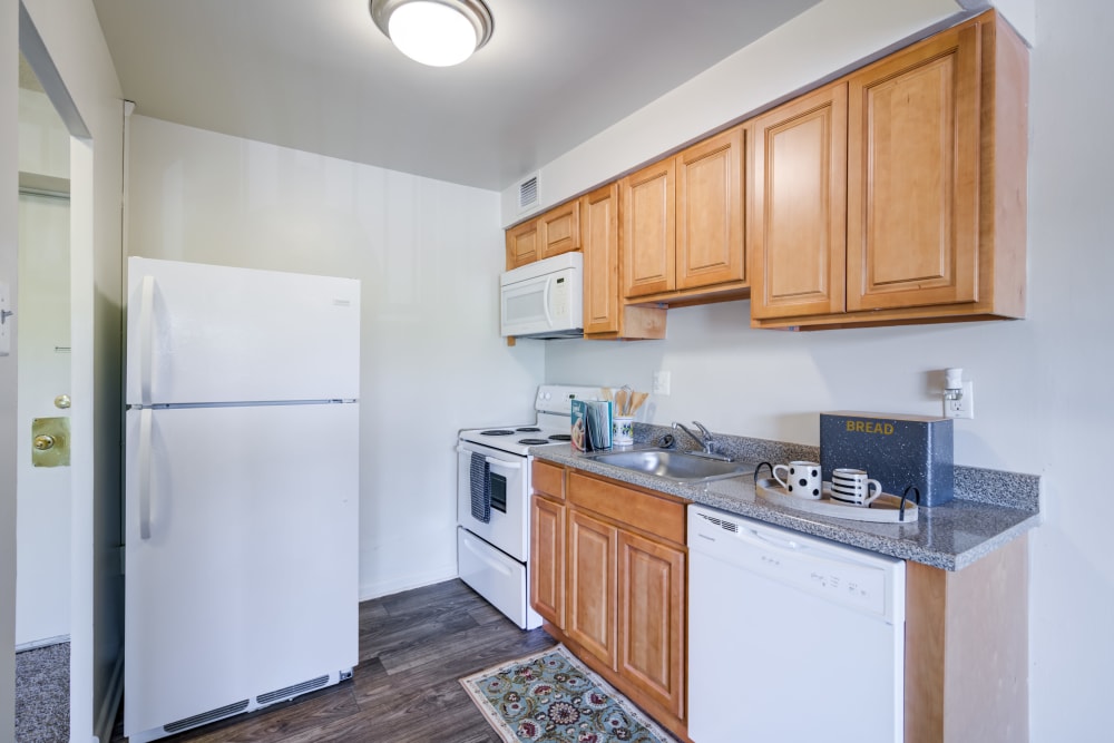 Kitchen with maple cabinets and a full appliance package at Lexington House Apartment Homes in Cherry Hill, New Jersey