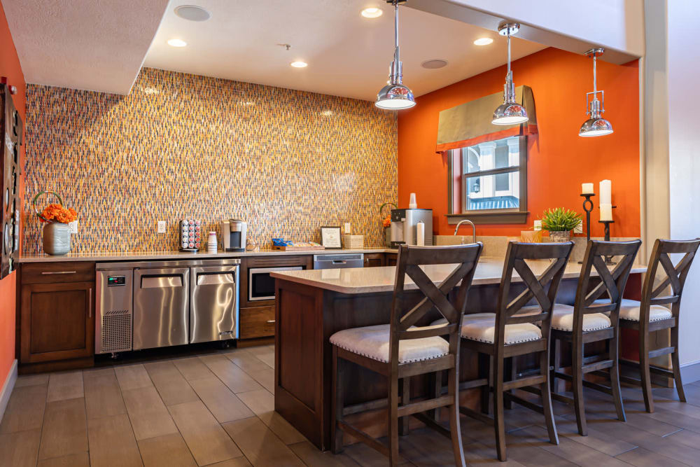 Clubhouse at Meadowbrook Station Apartments in Salt Lake City, Utah features a community kitchen with bar style seating.