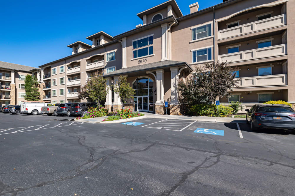  exterior of apartment, buildings and parking lot area outside entrance to Meadowbrook Station Apartments in Salt Lake City, Utah