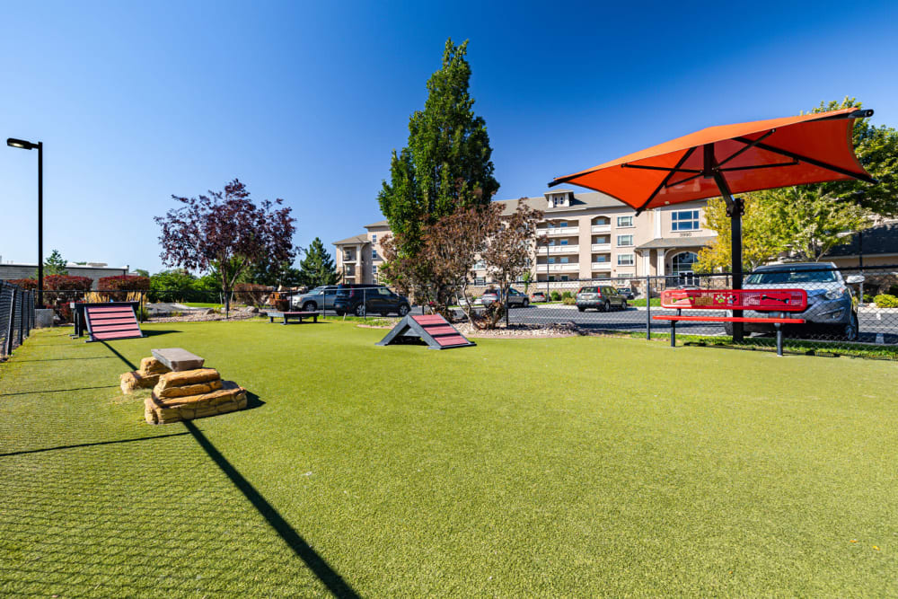 Dog Park featuring agility equipment, and sunshade area at Meadowbrook Station Apartments in Salt Lake City, Utah