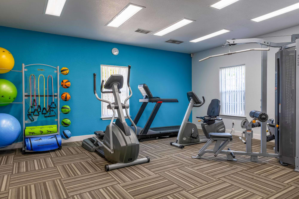 Fitness center at Country Ranch Apartments in Fort Collins, Colorado offers a variety of exercise equipment.