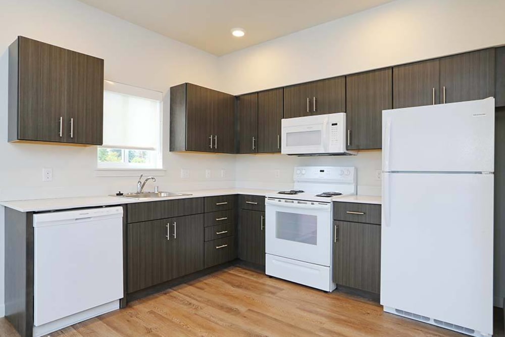 Kitchen with brown cabinets at Cedar Pointe in Arlington, Washington