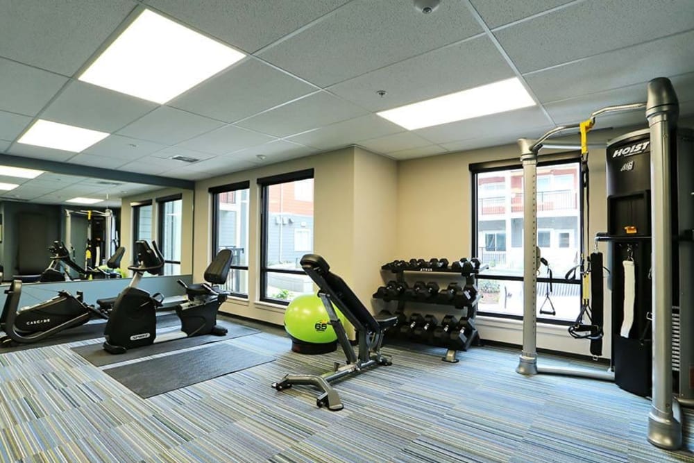 Modern gym fitness room with large windows and treadmills at Cedar Pointe in Arlington, Washington