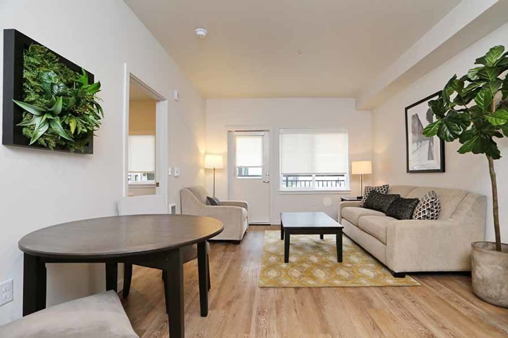 Model living room with hardwood floors at Cedar Pointe in Arlington, Washington