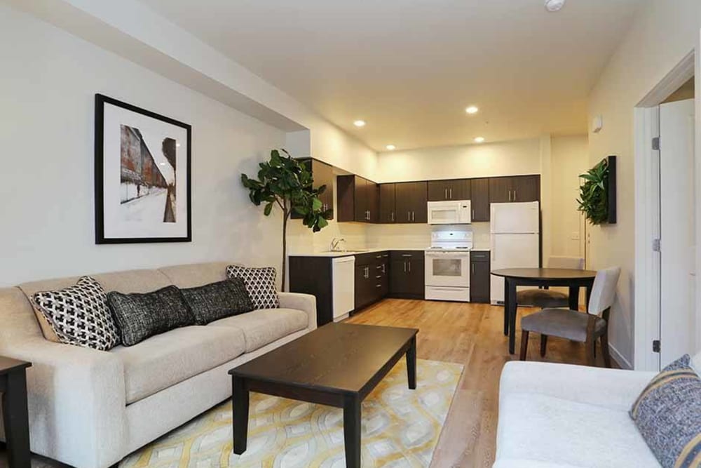 Model living room with an area rug at Cedar Pointe in Arlington, Washington