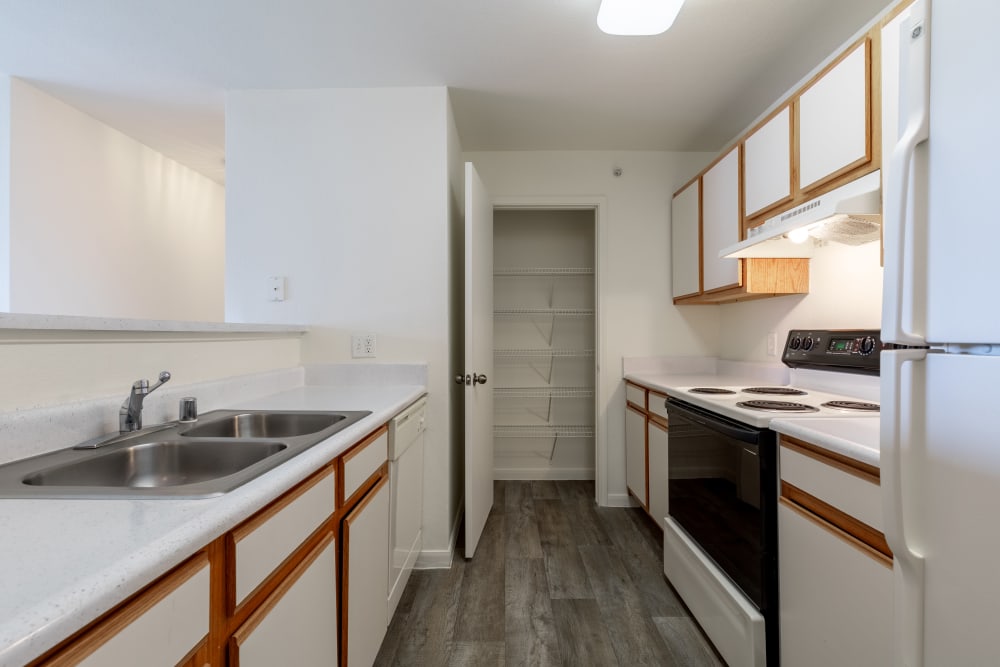 Bright white kitchen finishes featured in an apartment at Cloverbasin Village in Longmont, Colorado