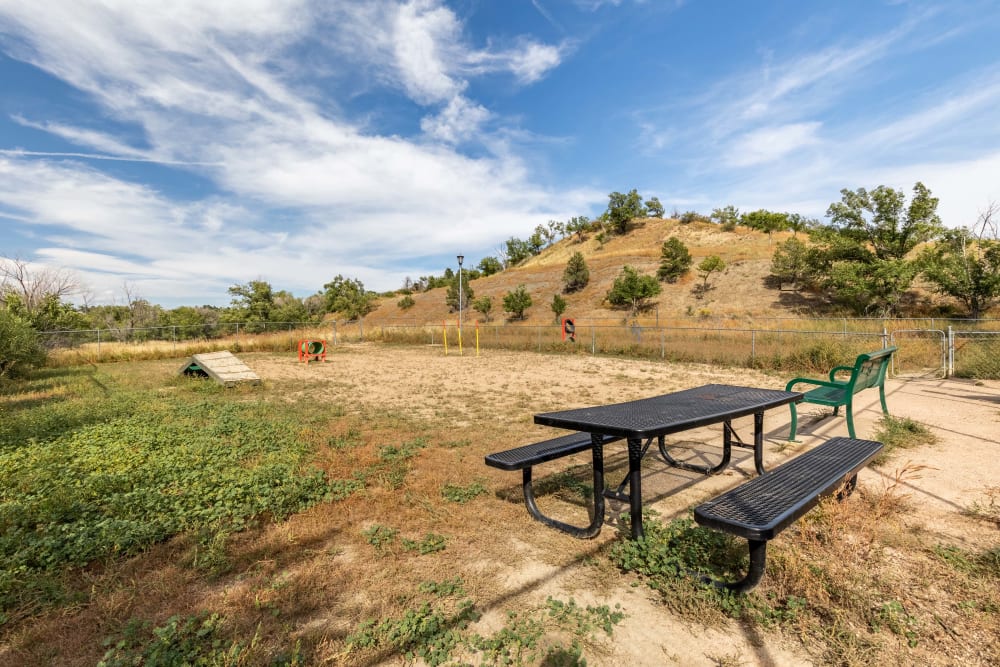 Picnic table inside dog park at The Knolls at Sweetgrass Apartment Homes in Colorado Springs, Colorado