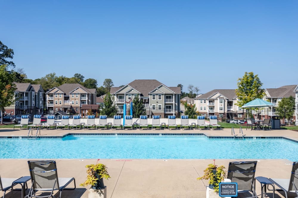 Outdoor community swimming pool features lounge chair seating at The Retreat at Arden Village Apartments in Columbia, Tennessee