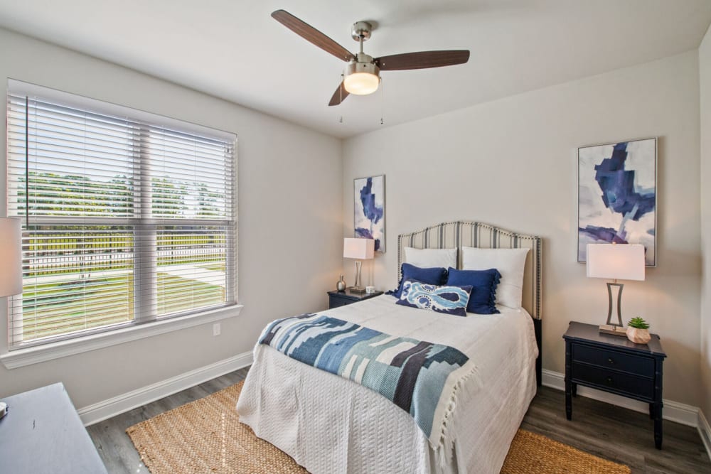 Model bedroom with wall art at The Waters at Hammond in Hammond, Louisiana