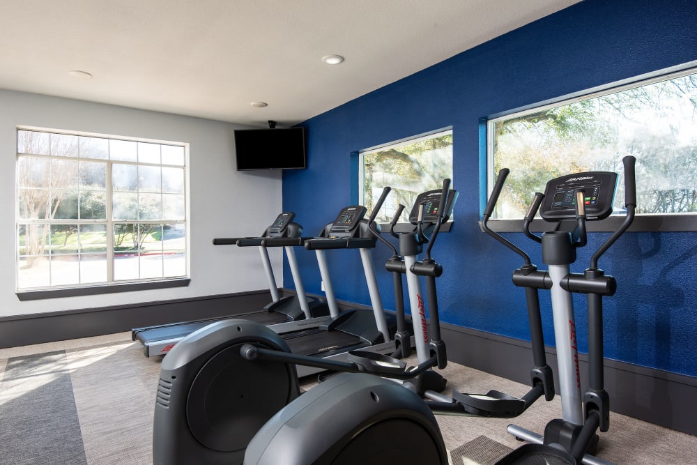 Fitness center with step machines at Ellie Apartments in Austin, Texas