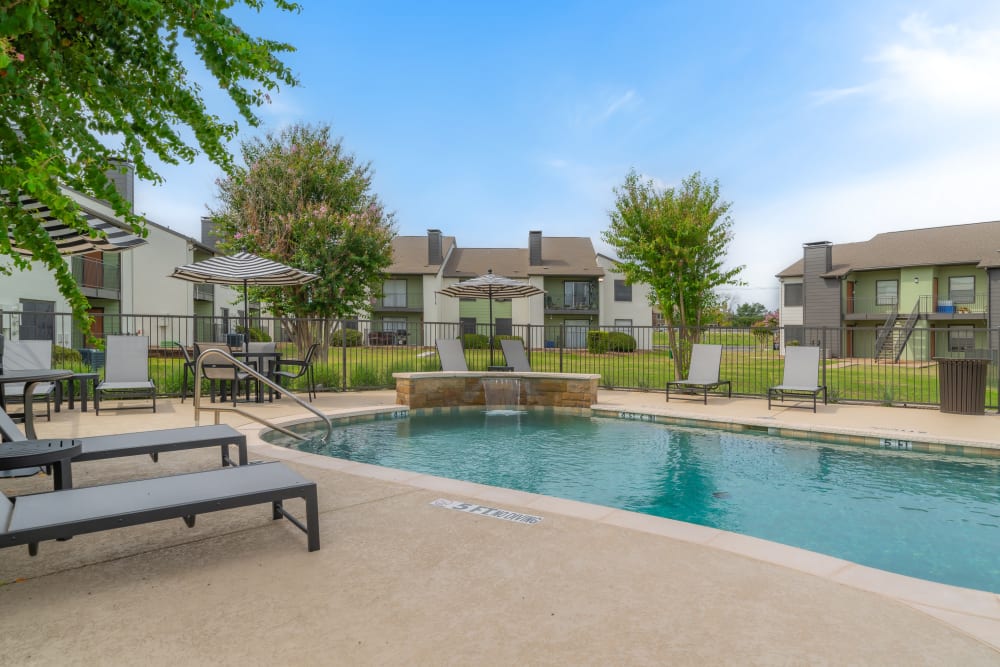 Pool with Sunloungers  at Leander Apartment Homes in Benbrook, Texas