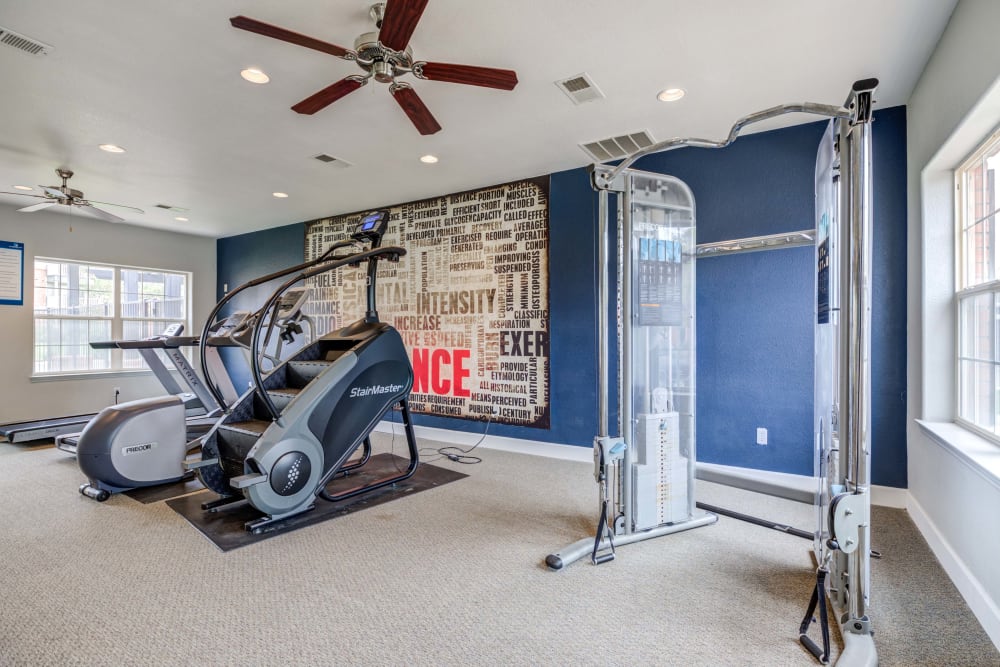 Variety of workout equipment at fitness center at Centennial East Apartments in Englewood, Colorado