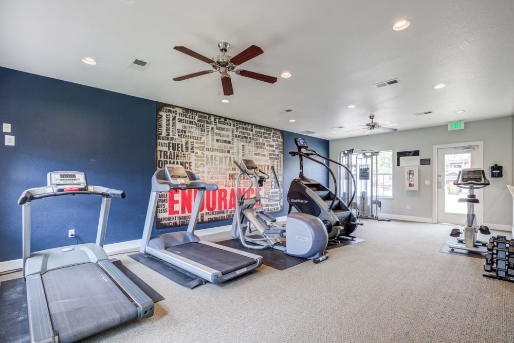 Fitness center featuring treadmilols and other equipment at Centennial East Apartments in Englewood, Colorado