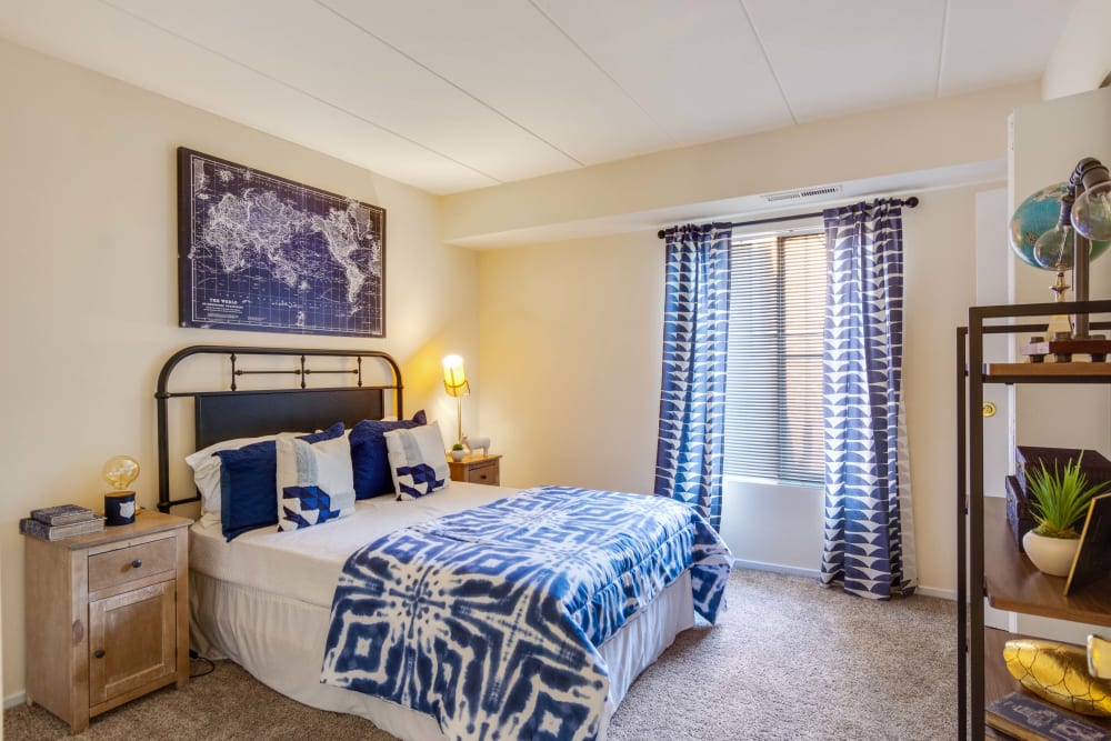 Cozy bedroom with large window at Parkway Apartments in Williamsburg, Virginia