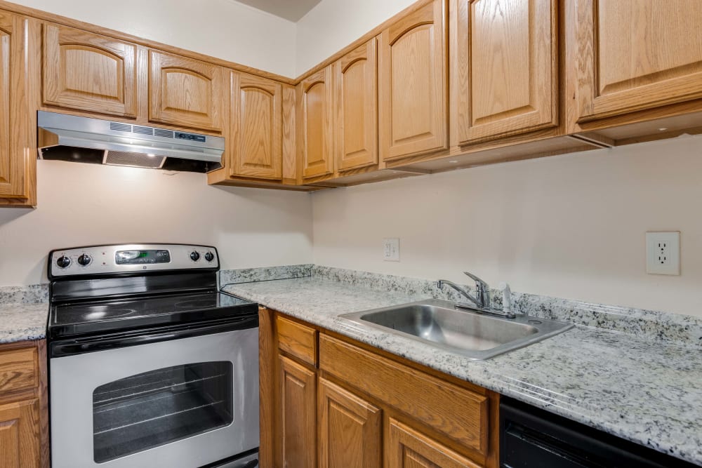 Kitchen with stainless steel oven and ample countertop and cabinet space at Parkway Apartments in Williamsburg, Virginia