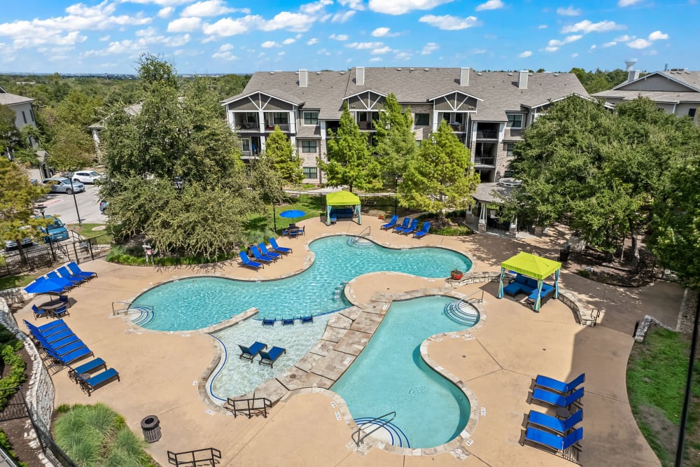 Sun chairs next to the pool at Marquis on Lakeline in Cedar Park, Texas