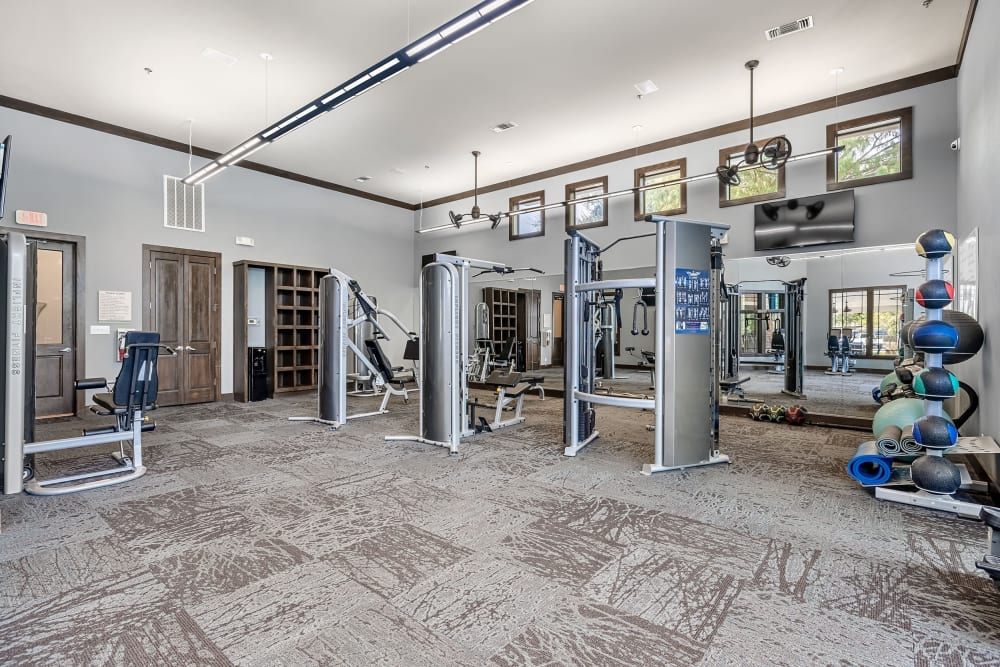 Weight machines and benches in the fitness center at Marquis on Lakeline in Cedar Park, Texas