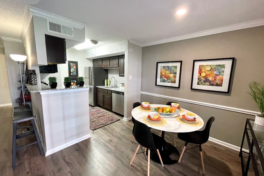 Dining nook and kitchen in a model apartment at The Abbey at Montgomery Park in Conroe, Texas