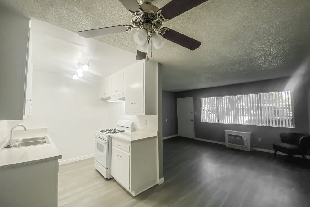 Model apartment with ceiling fan and hardwood floors at Golden Oaks in Riverside, California