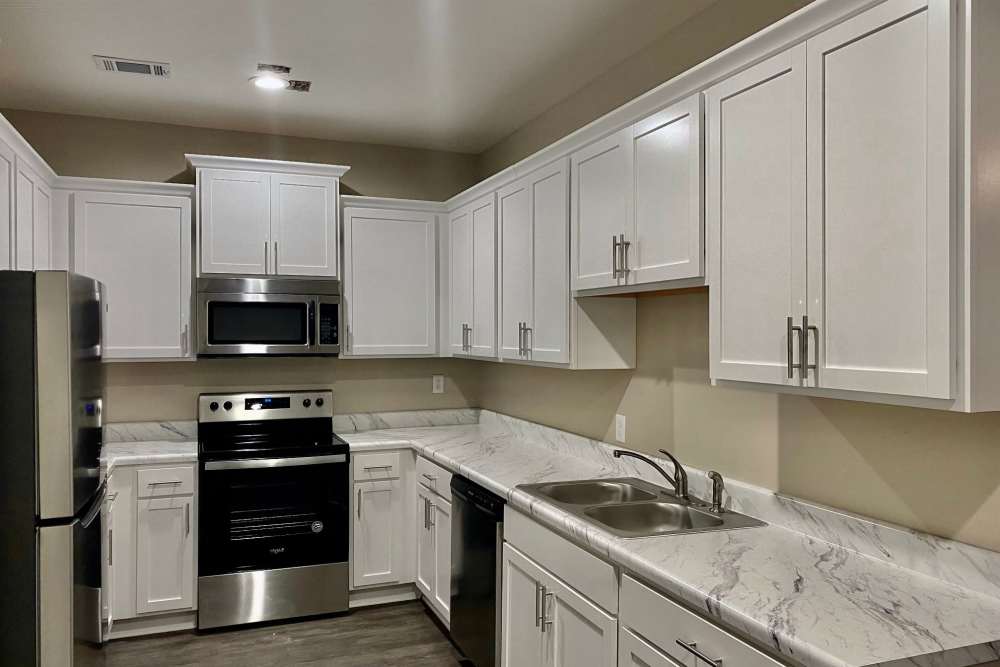 Kitchen with white cabinetry in a model home at Patriots Place in Valdosta, Georgia