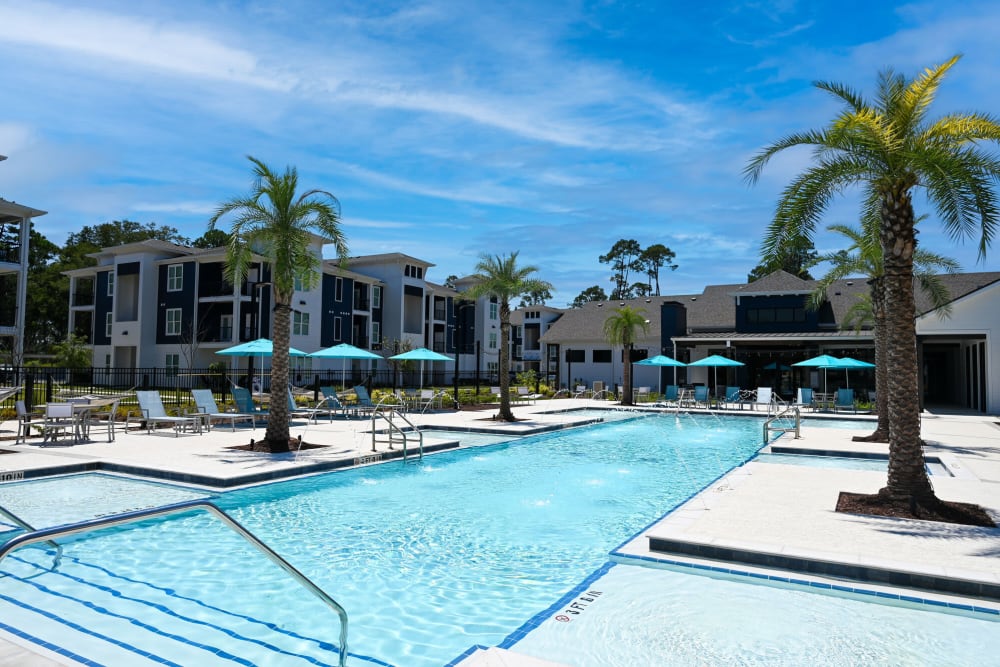 Swimming pool with palm trees at The Waters at Ransley in Pensacola, Florida
