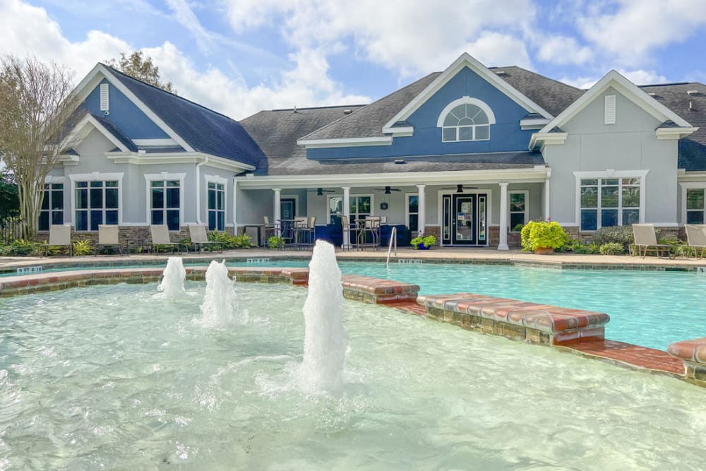 Resort style swimming pool with water features at Villas at West Road in Houston, Texas