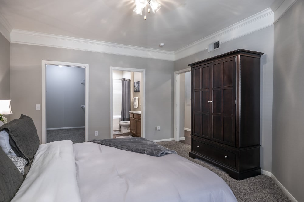 Master bedroom with plush carpeting at Villas at West Road in Houston, Texas
