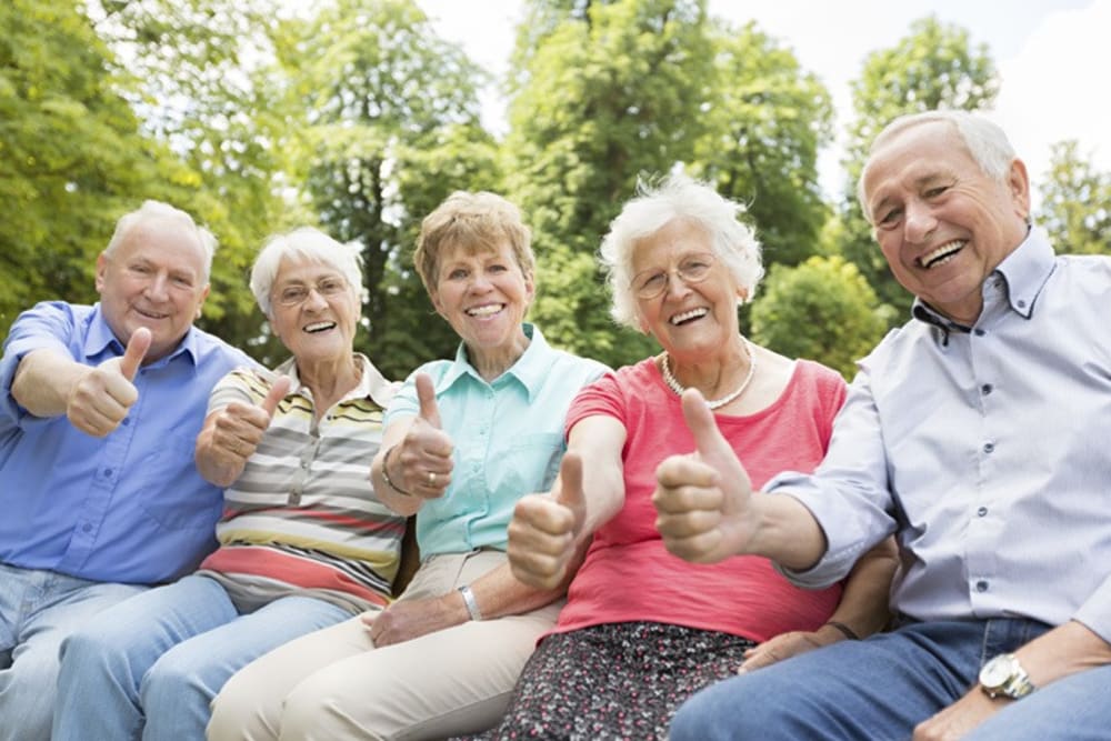 Residents giving a thumbs up gesture to the camera