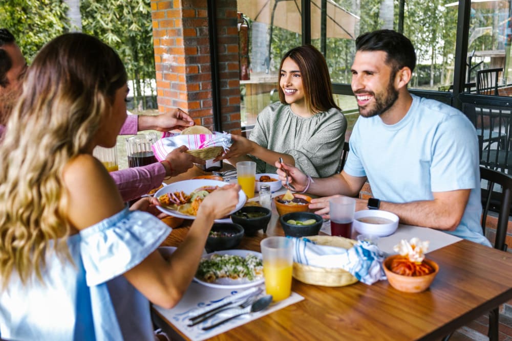 Residents enjoying lunch together at their favorite restaurant near Peppertree Place Apartments in Riverside, California