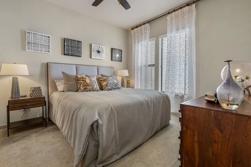 Large open bedroom with side tables and private bathroom at Marq Uptown in Austin, Texas