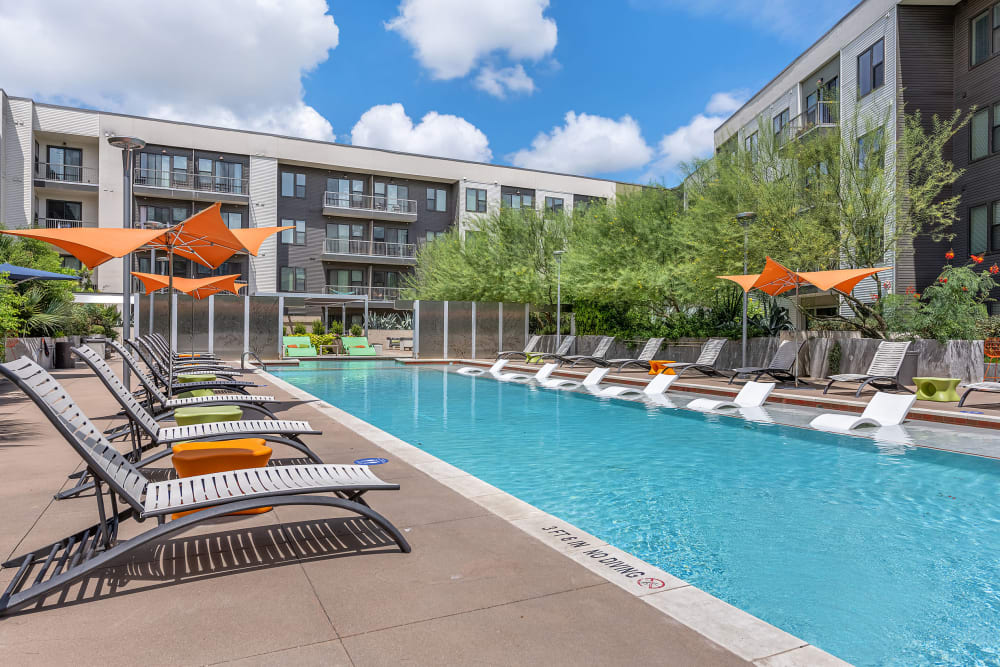 Sparkling resort style pool with lounge chairs at Marq Uptown in Austin, Texas