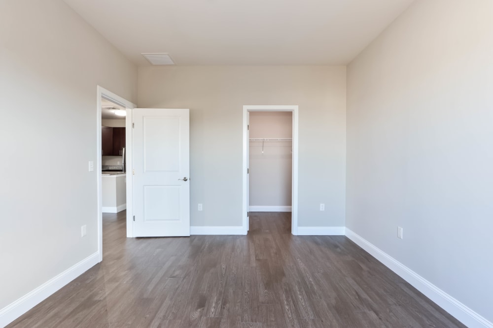 Large bedroom with wood flooring and closet in a model home at Five 10 Flats in Bethlehem, Pennsylvania