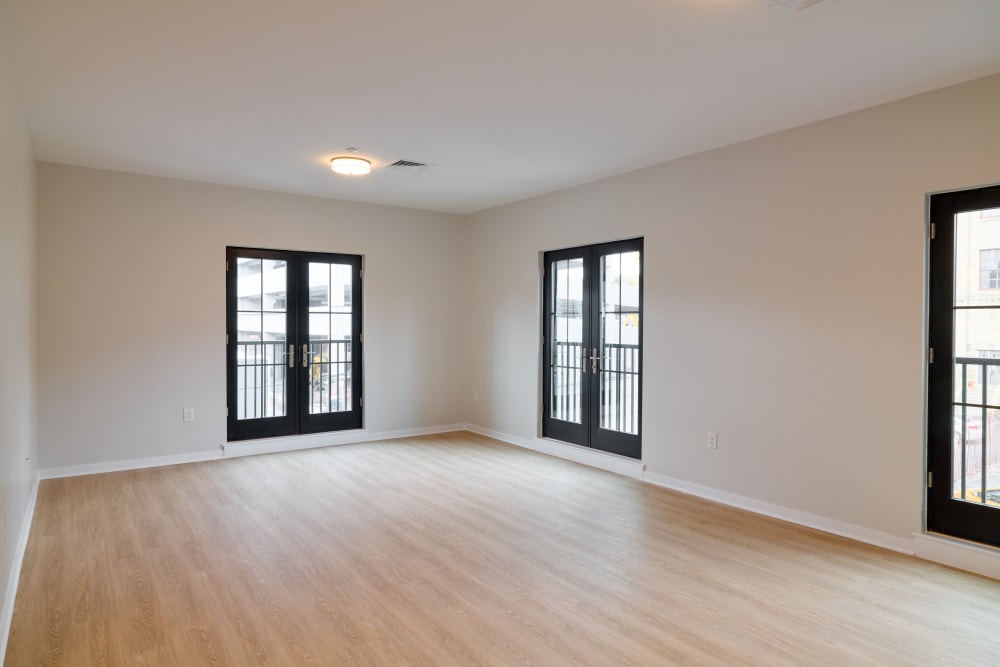 Cozy living room space with plenty of natural lighting in an unfurnished model home at The Seville Apartments in Easton, Pennsylvania