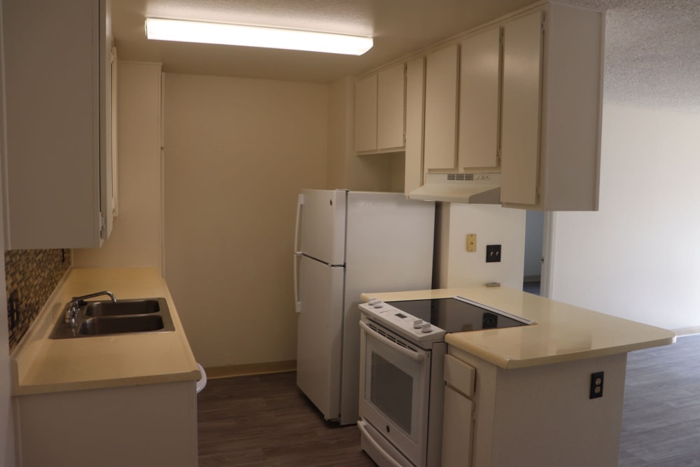 Kitchen with appliances at Gramercy Apartments in San Diego, California