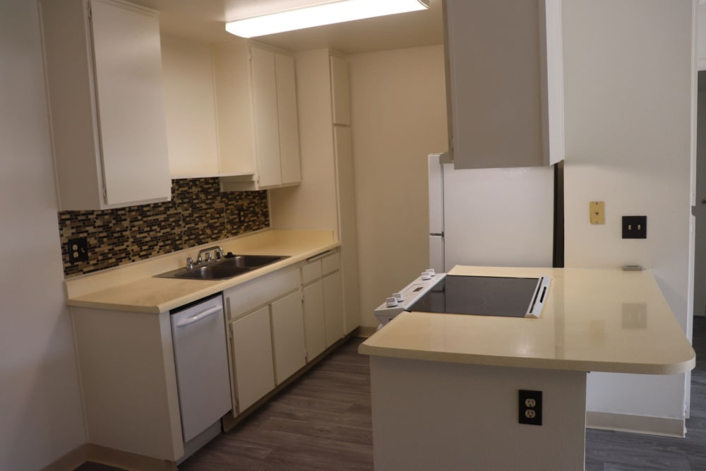 Model kitchen with hardwood floors at Gramercy Apartments in San Diego, California