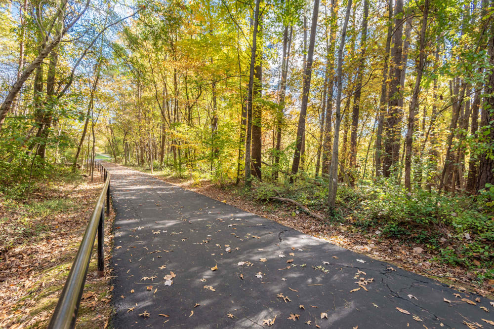 Walking and biking path along wooded area by Abbotts Run Apartments in Alexandria, Virginia.