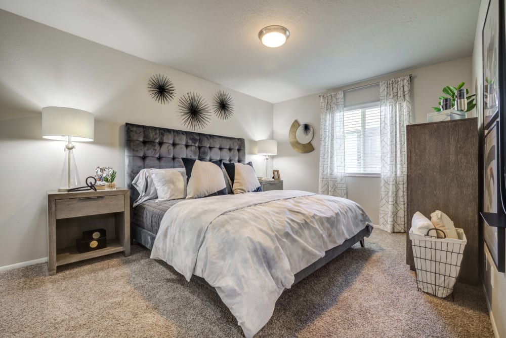 Cozy bedroom at Cherry Creek Apartments in Riverdale, Utah