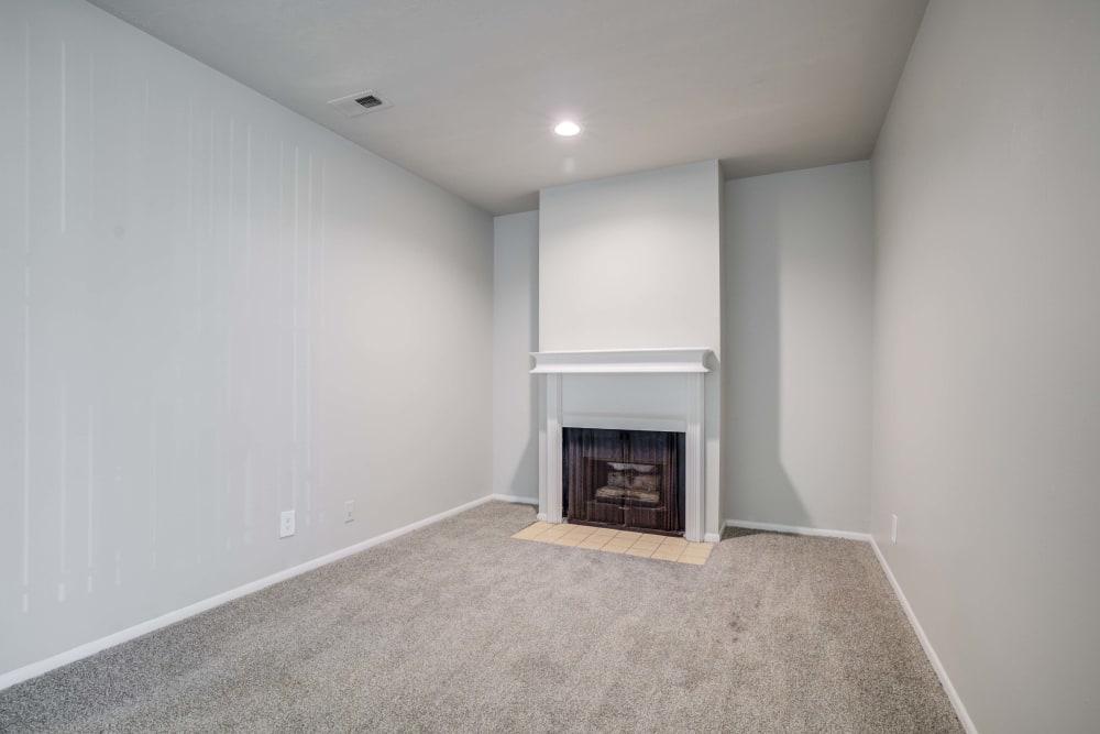 Living room featuring a fireplace at Cherry Creek Apartments in Riverdale, Utah