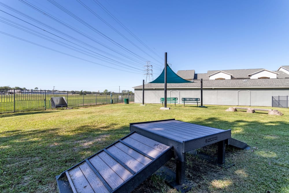 Signature Point Apartments in League City, Texas features a dog park with agility equipment.
