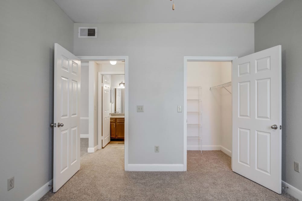 Bedroom with walk-in closet at Signature Point Apartments in League City, Texas