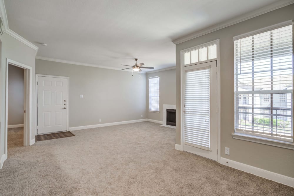 A living room at Signature Point Apartments in League City, Texas offers and abundance of natural light from the apartment's large windows.