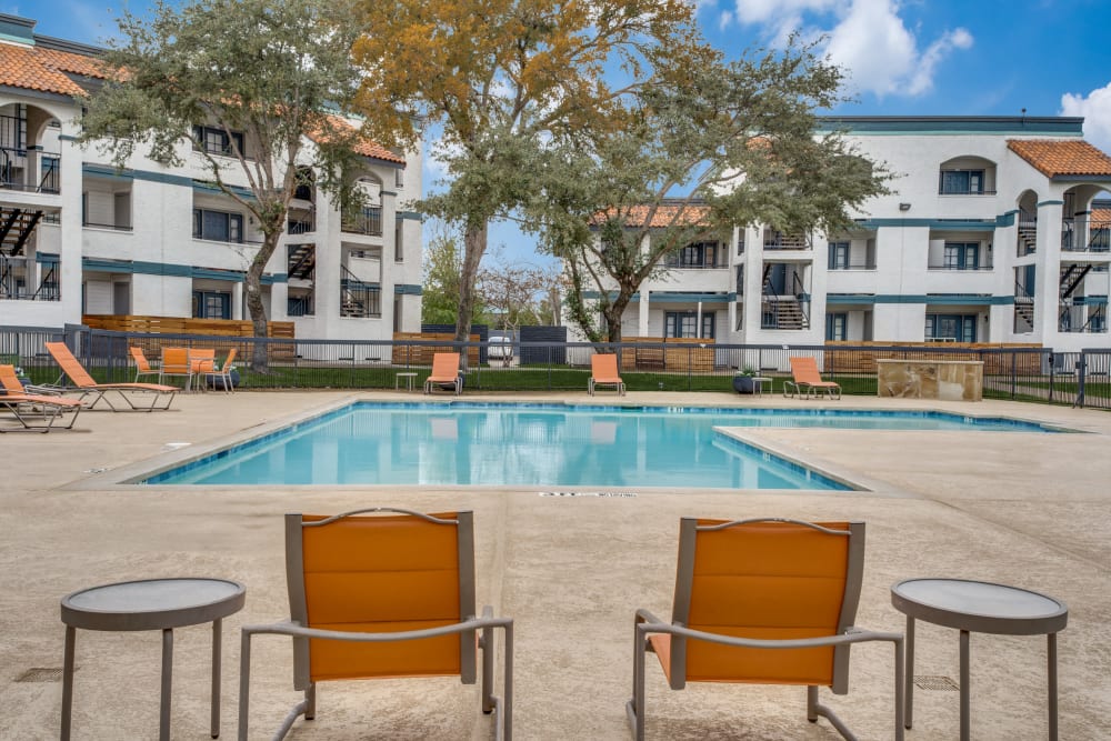 Pool with chairs at Mateo Apartment Homes in Arlington, Texas