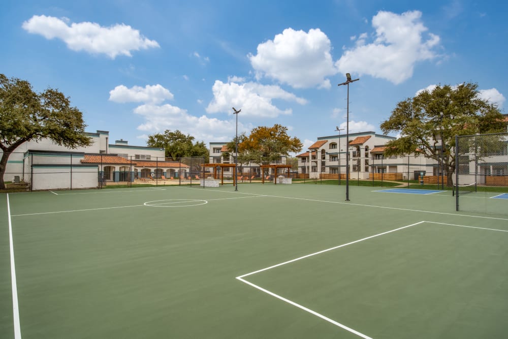 Tennis courts with space at Mateo Apartment Homes in Arlington, Texas