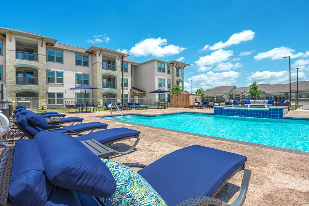 Swimming pool with chairs at The Preserve at Gateway in Forney, Texas