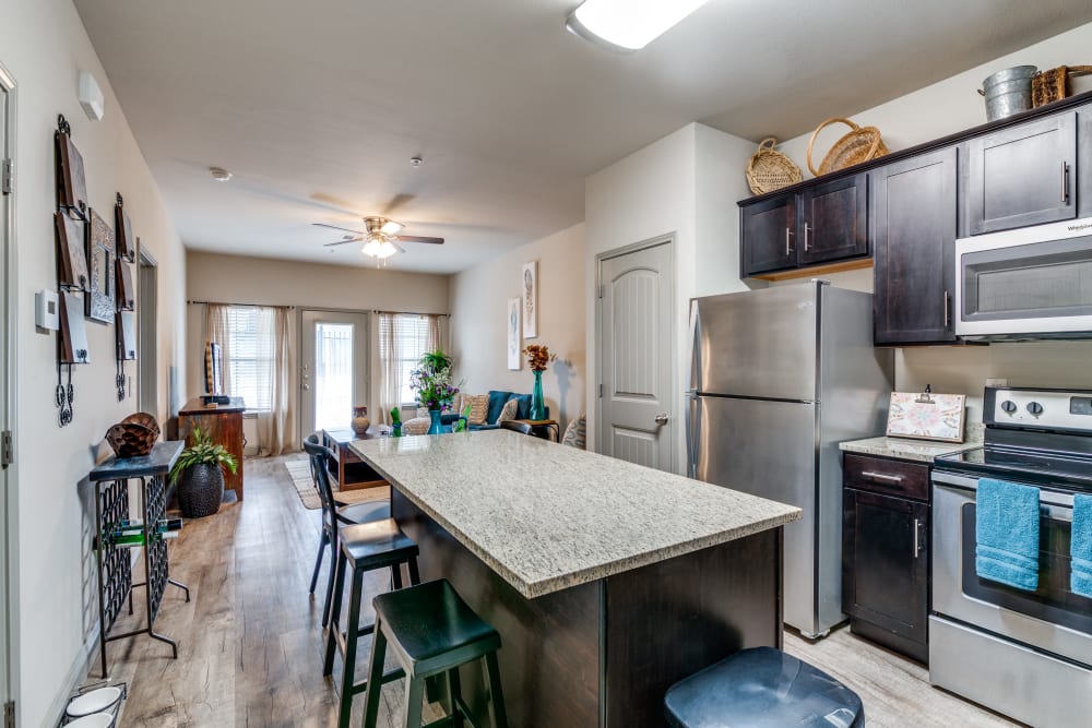 Kitchen with nice bar at Remi Apartment Homes in White Settlement, Texas