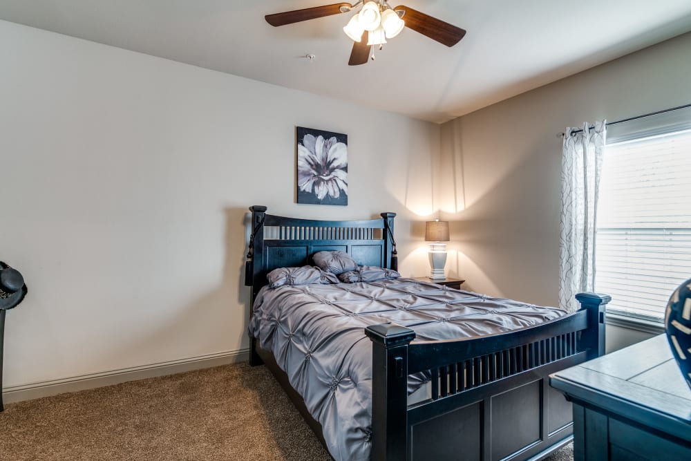 Bedroom with fan at Remi Apartment Homes in White Settlement, Texas