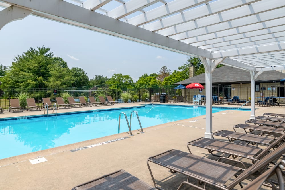 Swimming pool with lounge chairs at Cranbury Crossing Apartment Homes in East Brunswick, New Jersey