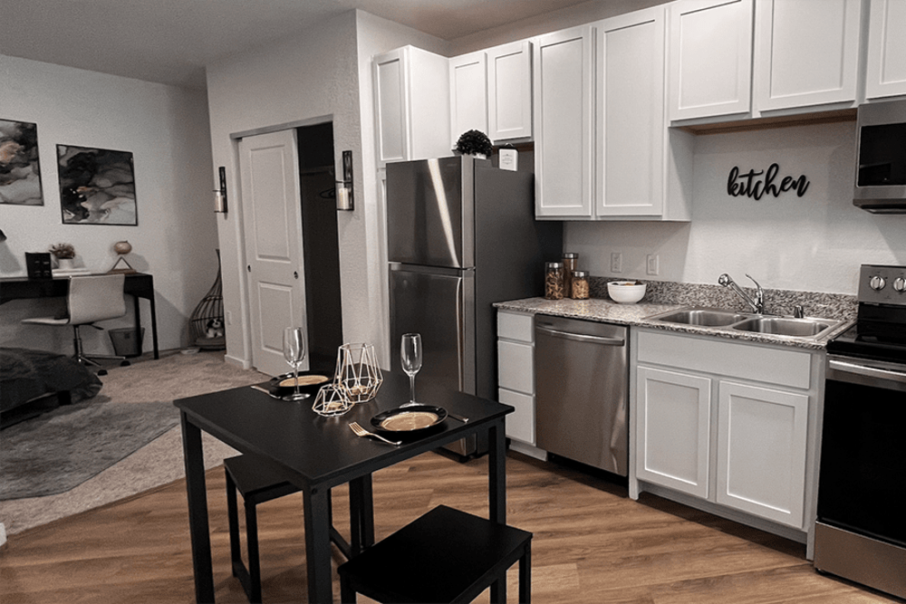 Kitchen with white cabinetry at The Deco at Victorian Square in Sparks, Nevada