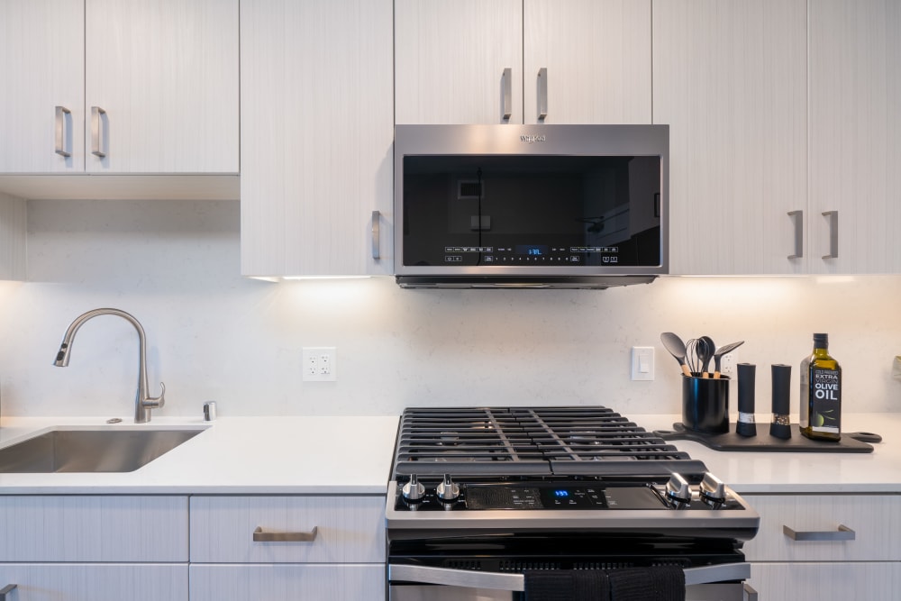Kitchen with white countertops and cabinetry at MV Apartments in Mountain View, California