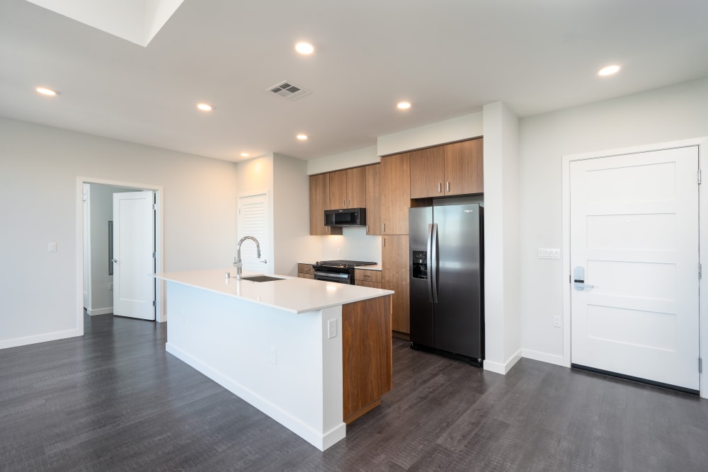 Living area and kitchen with hardwood-style flooring in a penthouse at MV Apartments in Mountain View, California